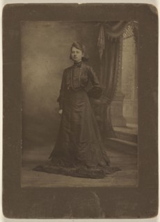 Portrait of a young woman in long black dress, standing; George W. Killian, American, 1876 - 1938, about 1900; Gelatin silver
