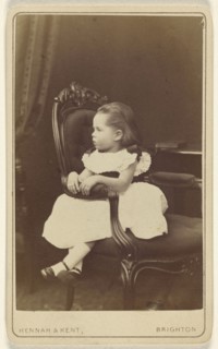 Little girl seated sideways in an armchair; Hennah & Kent; about 1870; Albumen silver print