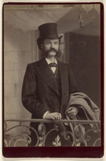 man with moustache and muttonchops wearing fancy clothes and a top hat; about 1885; Albumen silver print