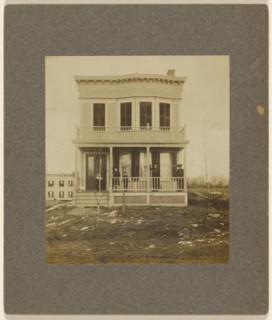 View of a Victorian-style house with five people on the front porch; 1890s; Gelatin silver print
