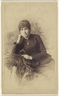 woman seated with hand on cheek, posed on a pile of hay; Miller & Company; 1880s; Albumen silver print