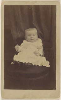 baby seated in dark-colored chair with tassels; Peter S. Weaver, American, active Hanover, Pennsylvania 1860s - 1910s