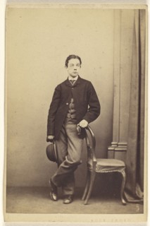 young man with derby in hand, with other hand on chair back, standing; Thomas Edge, British, active 1850s - 1870s, 1865-1870