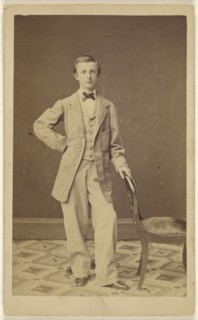 well-dressed young man wearing a bowtie, standing; 1861; Albumen silver print