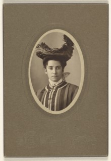 woman wearing a feathered hat, printed in oval cut; Bloomingdale Brothers; October 1904; Gelatin silver print
