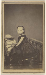 little girl standing, leaning on a prop in a studio; S. Bruckner; 1865 - 1870; Albumen silver print