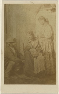 Woman seated holding a baby, a man and woman on either side; 1865 - 1870; Albumen silver print
