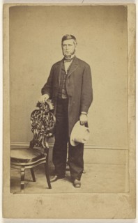 man with long muttonchops, standing, holding a white hat; Charles E. Crouse, American, active 1870s, 1870-1875; Albumen silver