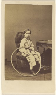 little boy seated, holding a large hoop; Désiré Durand, French, active 1860s, 1865 - 1870; Albumen silver print