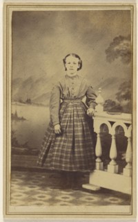 young woman in a studio setting, standing; 1865 - 1870; Albumen silver print
