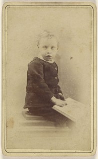little boy seated with an open book on his lap; John McKean, Scottish, active Leith, Scotland 1880s - 1890s, 1870 - 1880