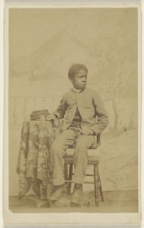 African-American boy in uniform, seated in 3,4 profile; 1870-1875; Albumen silver print