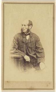 man with long, bushy muttonchops, seated in a chair with tassels; Alexander Gardner, American, born Scotland, 1821 - 1882