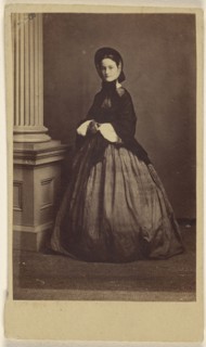 woman wearing a bonnet, standing; French; 1862 - 1864; Albumen silver print