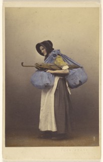 elderly woman wearing a bonnet and native costume standing, carrying sacks and a parasol; Thomas Edge, British, active 1850s