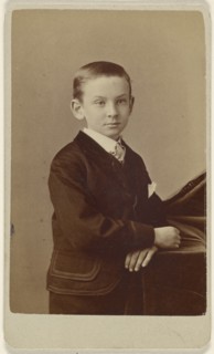 little boy standing, leaning on cloth-covered table; Alva Pearsall, American, 1838 - 1893, active Brooklyn, New York)