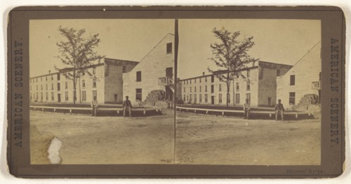 Hudson River. Two men sitting on a railing outside a large building complex; American; about 1870; Albumen silver print