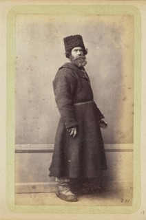 Bearded man posing in long, dark coat and wool hat; William Carrick, Scottish, 1827 - 1878, Russia; about 1860 - 1870; Albumen