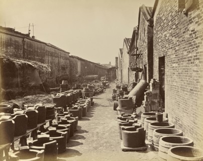 View of an alley bordered by brick buildings and containers on the ground; Unknown maker; China; about 1870; Albumen silver