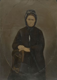 Portrait of woman in bonnet; United States; 1860s - 1880s; Hand-colored tintype; Sheet: 35.8 × 25.6 cm, 14 1,8 × 10 1,16 in
