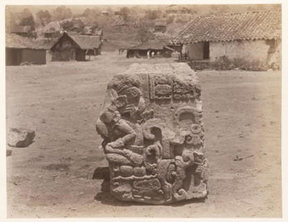 Carved block, with village buildings in background, Edmund Lincoln miscellaneous papers relating to the excavation of Maya ruins