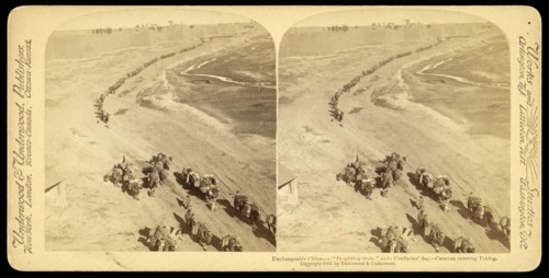 Unchangeable China, a 'freighting train' as in Confucius' day, caravan entering Peking, Underwood and Underwood, Gelatin silver
