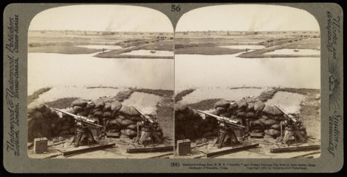 Destructive guns from H.M.S. 'Terrible' and distant burning city fired by their shells, Ricalton, James, Underwood and Underwood