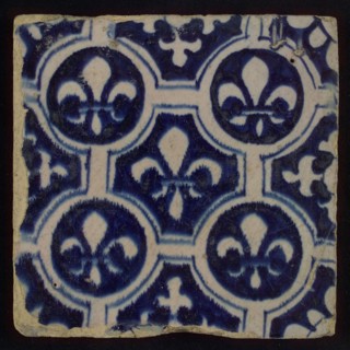 Two-tone tile, blue on white background, finished painting, four circles with white French lily around central ornament with