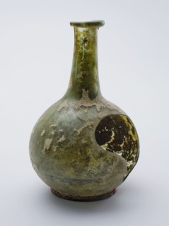 Bulky (medicine?) Bottle, bottle holder bottomfound glass, free blown and shaped Bolbuikig (medicine?) Bottle in clear light