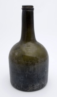 Cylindrical (wine) bottle, clock model, bottle holder soil find glass, free blown and molded in mold blown glass application