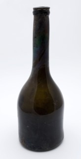 Brown, transparent, cylindrical bottle with long neck, bottle holder soil found glass, hand-blown glass application Cylindrical