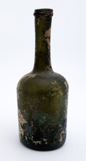 Cylindrical bottle, bottle holder bottomfound glass, free blown and shaped glass application Cylindrical bottle in clear green