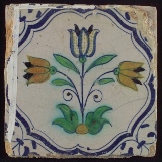Tile, three-tier in blue, green, orange and purple on white, inside frame with accolades, corner motif, wing, wall tile
