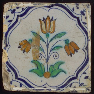 Tile, three-tier in blue, green, orange and purple on white, inside frame with accolades, corner motif, wing, wall tile