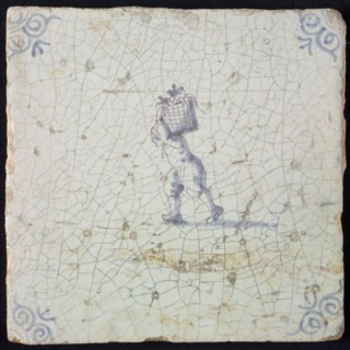 Occupation tile, blue with man crumbling with basket on the back, corner motif ox's head, wall tile tile sculpture ceramic