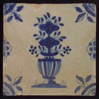 Tile, flowerpot in blue on white, corner motif spotted quarter rosette with lily, half rosette on left and right side, flowed