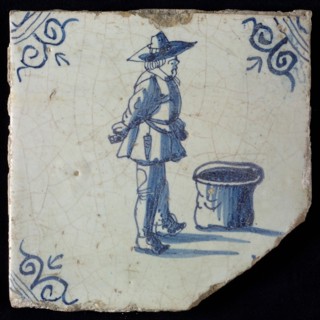 Occupation tile, blue with warrior standing by barrel, corner motif oxen head, wall tile tile sculpture ceramic earthenware