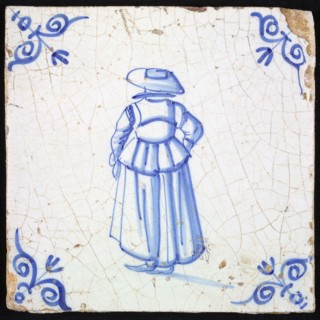 Figure tile, blue with lady with big hat, seen on the back, corner motif ox's head, wall tile tile sculpture ceramic earthenware