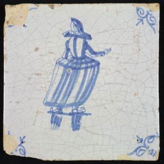 Figure tile, blue with skating lady with millstone collar seen from behind, corner motif oxen head, wall tile tile sculpture