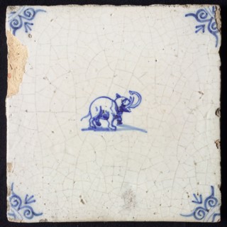 Animal tile, standing elephant to the right, in blue on white, corner motif of ox's head, wall tile tile sculpture ceramic