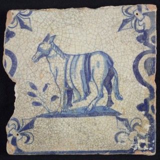 Animal tile, standing donkey or horse to the left on plot between balusters, in blue on white, corner pattern French lily, wall