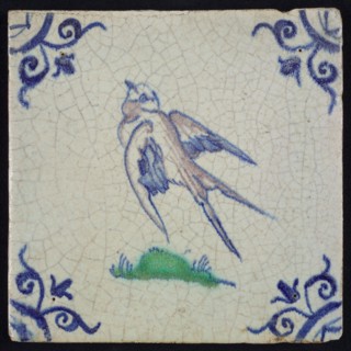 Animal tile, flying bird to the left in purple, green and blue on white, corner motif ox's head, wall tile tile sculpture