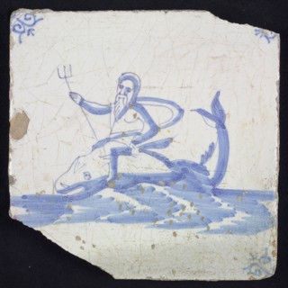 Sea Pewter, man with trident sitting on dolphin in running water to the left, in blue on white, corner motif oxen head, wall