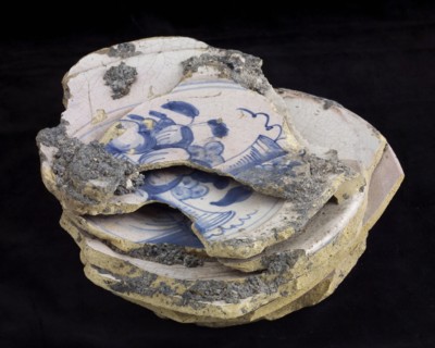 Stack of nine faience plates, baked misbakels with fruit as decor, plate crockery holder soil find ceramic earthenware enamel