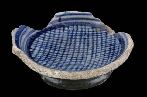 Fragment majolica bowl or salt shaker, blue on white, circle hatched in the middle, reverse side light green glaze, salt bowl