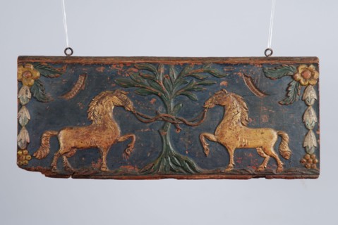 Wooden painted back plate of farm wagon, with image two gilded horses tied to tree, back crate wood carving sculpture footage