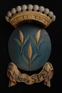 Carved wooden crowned coat of arms including the name G. Van der Spelt, with fragment that has been demolished on which part of