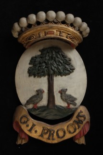 Carved wooden crowned coat of arms including the name G.I. Proons, coat of arms information form wood carving sculpture