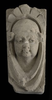 Keystone with gable head, female head with cap, keystone gable ornament building component limestone stone, sculpted Above wider
