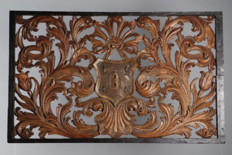 Skylight with carved leaf motifs, curling round coat of arms showing beehive and four bees, cutting frame light wood carving